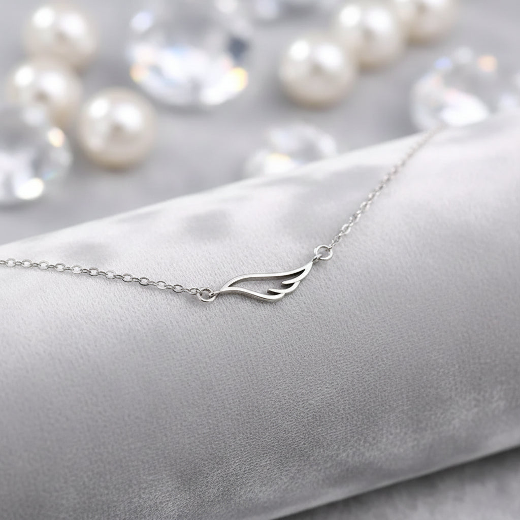 Angel Wing Necklace with a delicate wing design on a light gray background