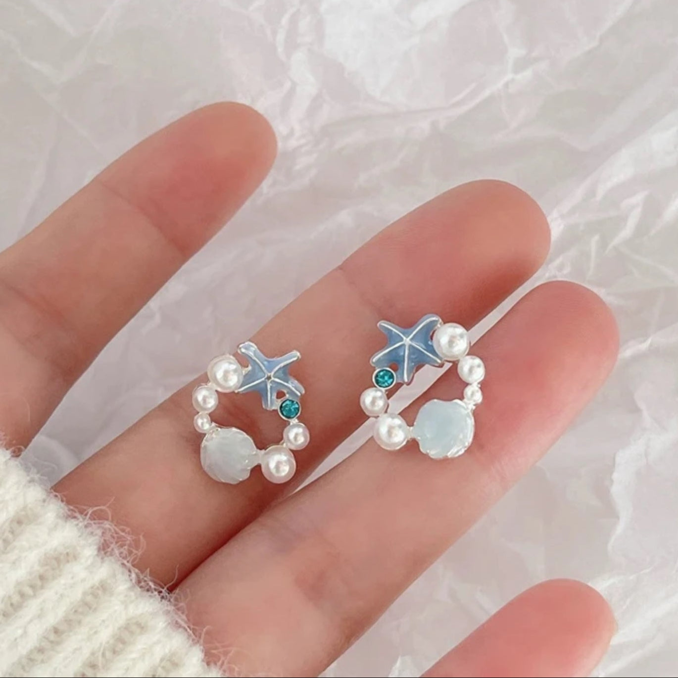 Woman holding in hand Starfish Seashell Pearl Earrings