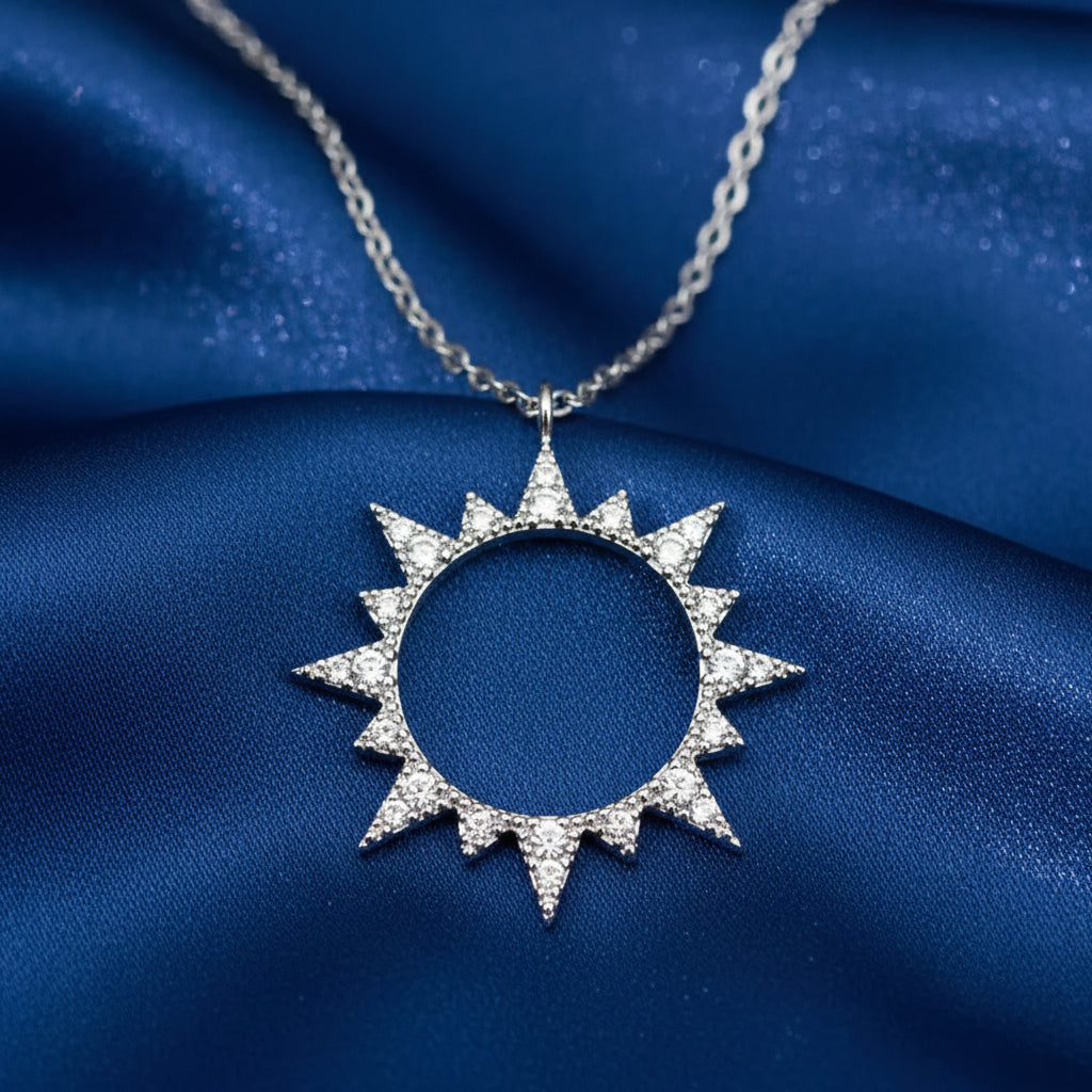 Silver Pavé Sunburst Necklace with clear stones on a dark background