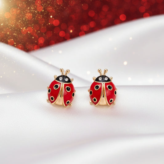 Bold Lucky Ladybug Earrings with gold accents on a white and red glittery background