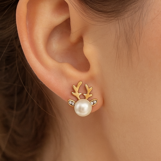 Snow Pearl Reindeer Earrings with gold accents being worn on an ear