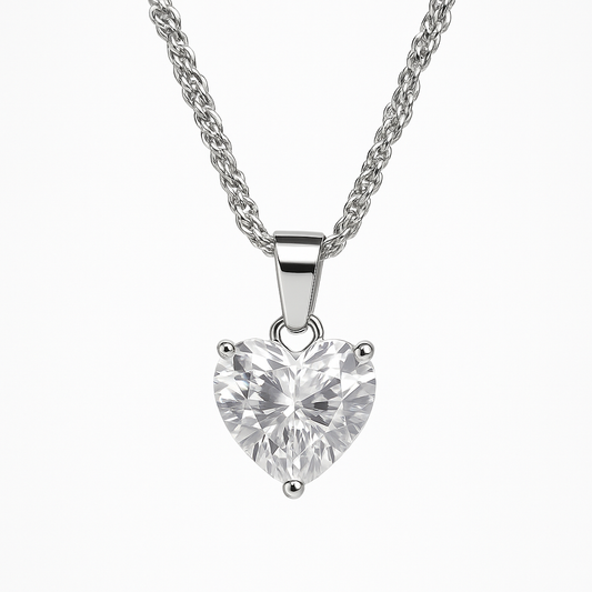 Heart-shaped diamond pendant on a silver chain against a white background