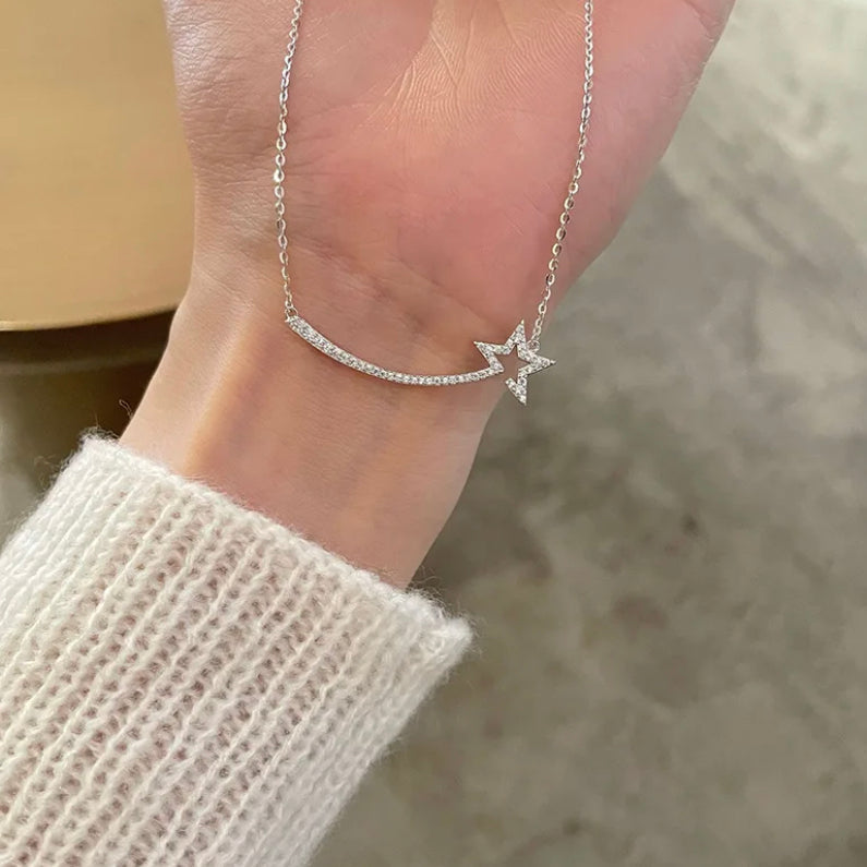 Silver Shooting Star Necklace in S925 sterling silver held by a woman