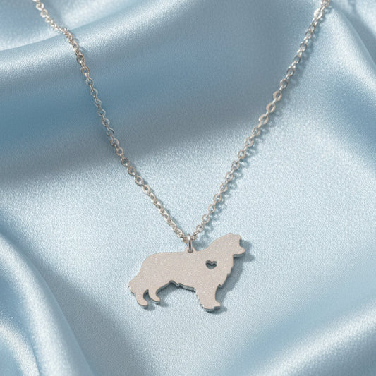 Silver Heartfelt Pup Silhouette Necklace on a light blue satin background