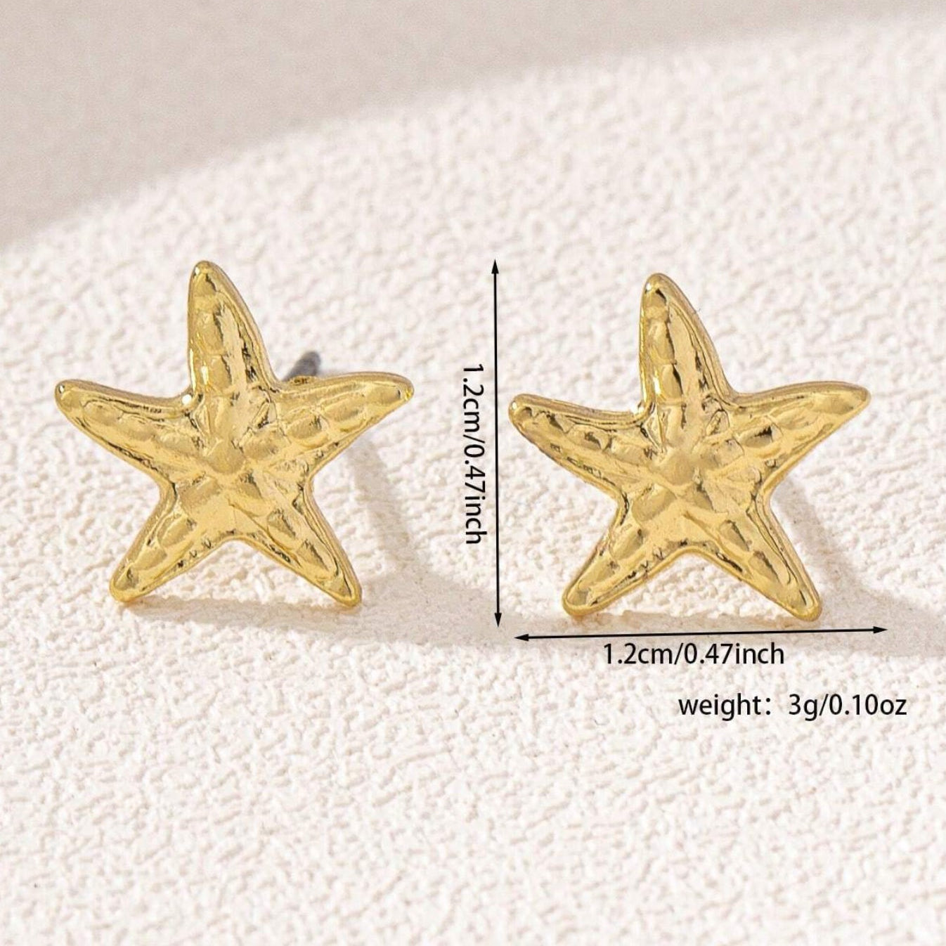 Gold Starfish Earrings with measurements and weight on a textured white background