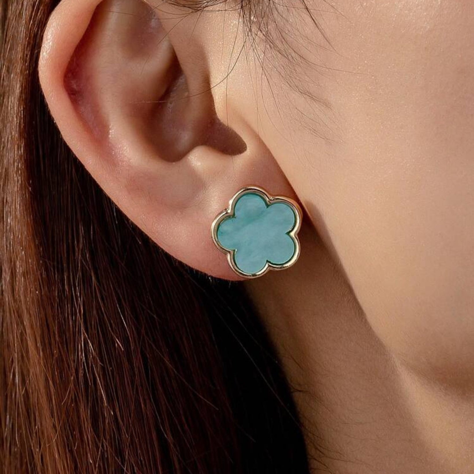 Aqua flower earrings on woman