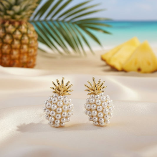 A pair of gold-tone pineapple-shaped earrings adorned with white imitation pearls.