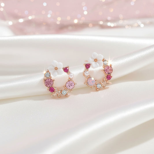 Pink & White Flower Wreath Earrings with pink gemstones on a soft pink background