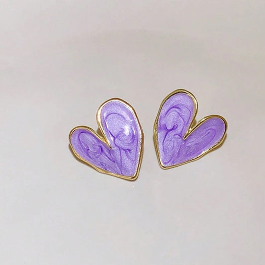 Heart-shaped earrings with purple design and gold outline on a white background