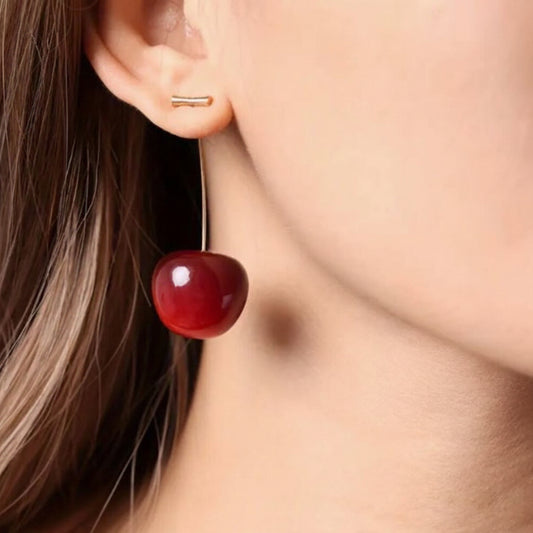 Close-up of a person wearing a Red Cherry Drop Earring.