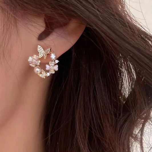 Close-up of an ear wearing a decorative earring with a blurred background