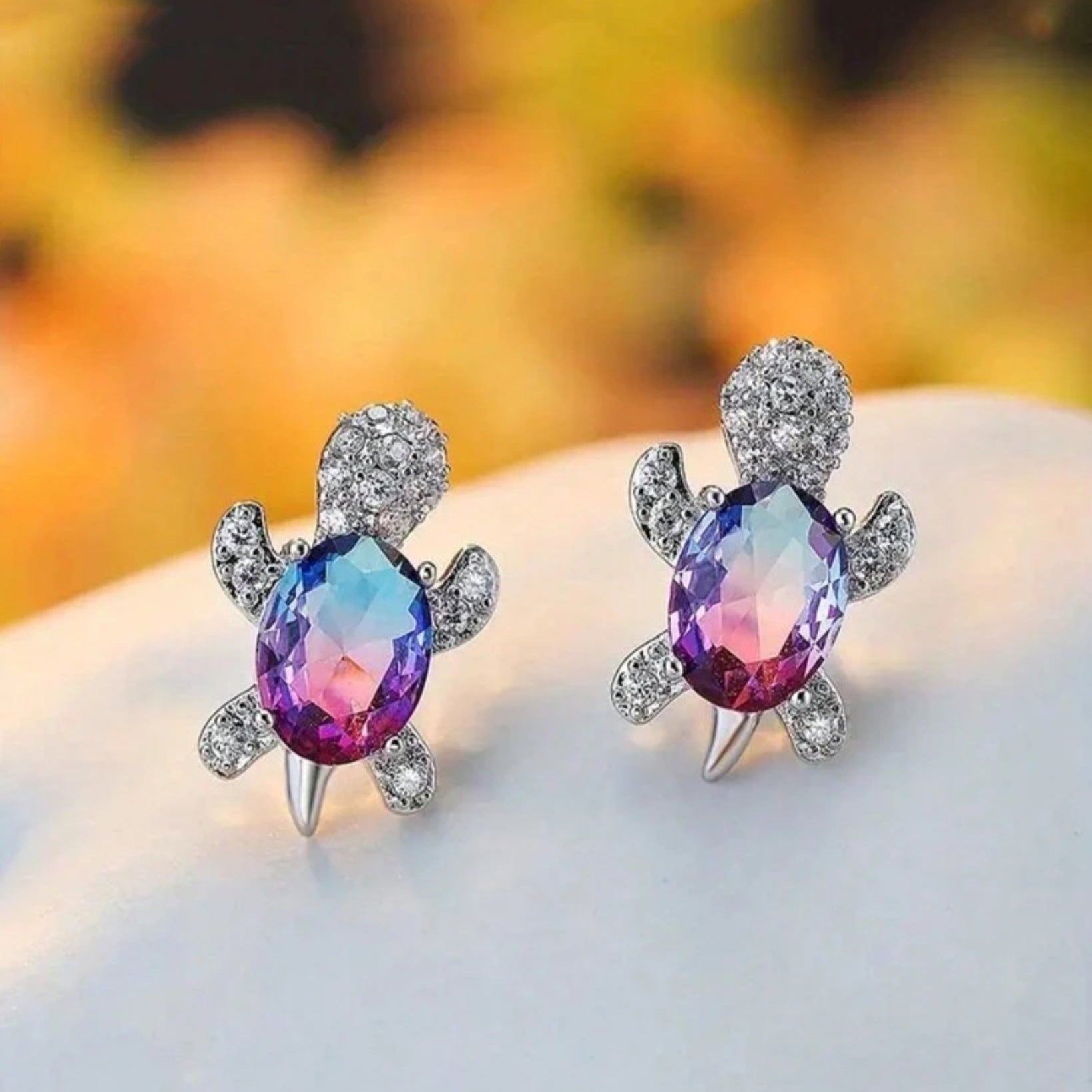 Silver turtle-shaped stud earrings with multicolor crystal shell design