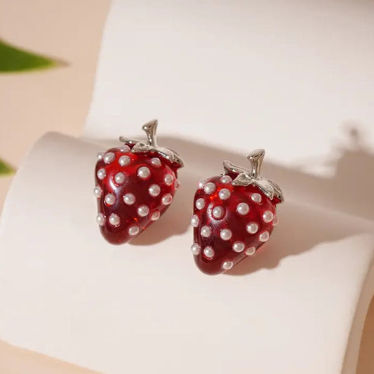 Strawberry Pearl Earrings: Strawberry-shaped earrings with pearl details on a white surface