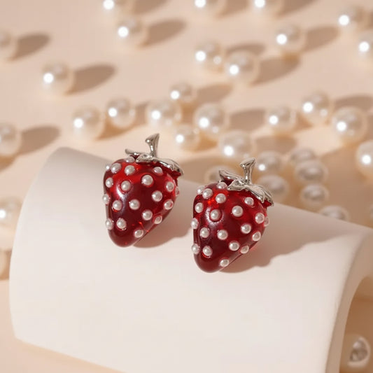 Strawberry Pearl Earrings: Strawberry-shaped earrings with pearl details on a white surface