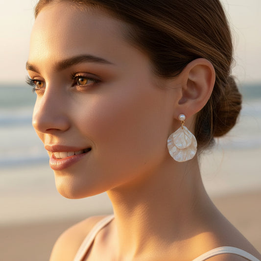 Pearl Shell Earrings worn by a person against a neutral background