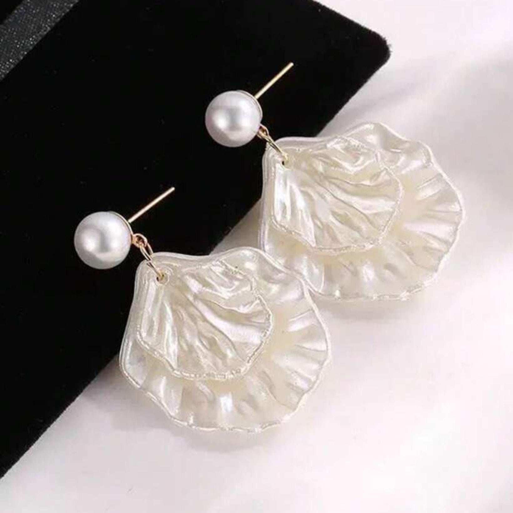 Pearl shell drop earrings with gold post and layered iridescent petal design