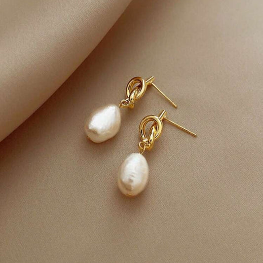 Gold knot drop earrings with classic pearl accents, elegant dangle style