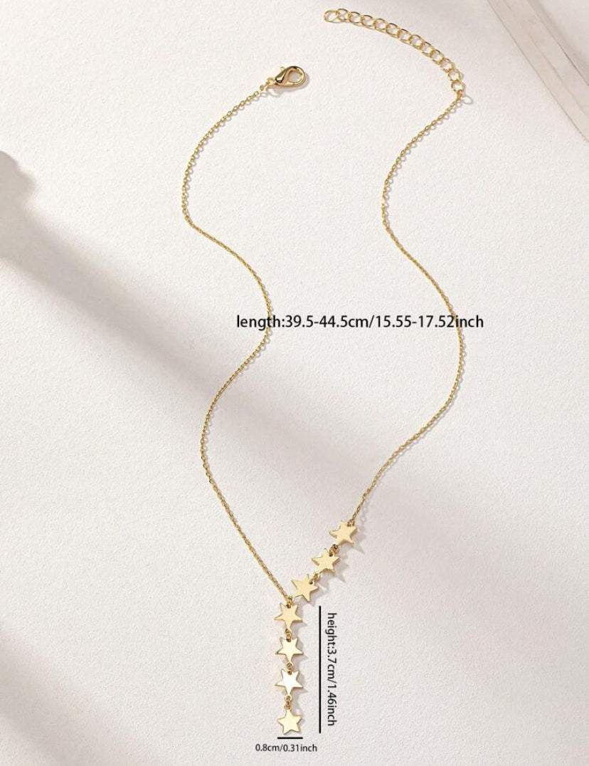 Gold necklace with star pendants on a light background