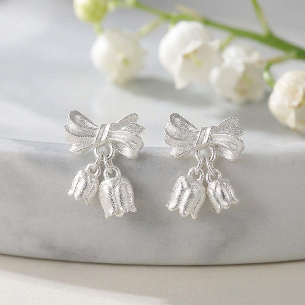Gold bow earrings with delicate bellflower-shaped dangles