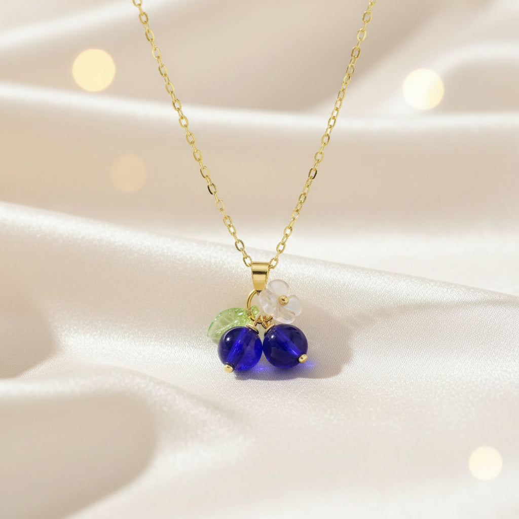 Necklace with purple beads and a green leaf charm on a light background