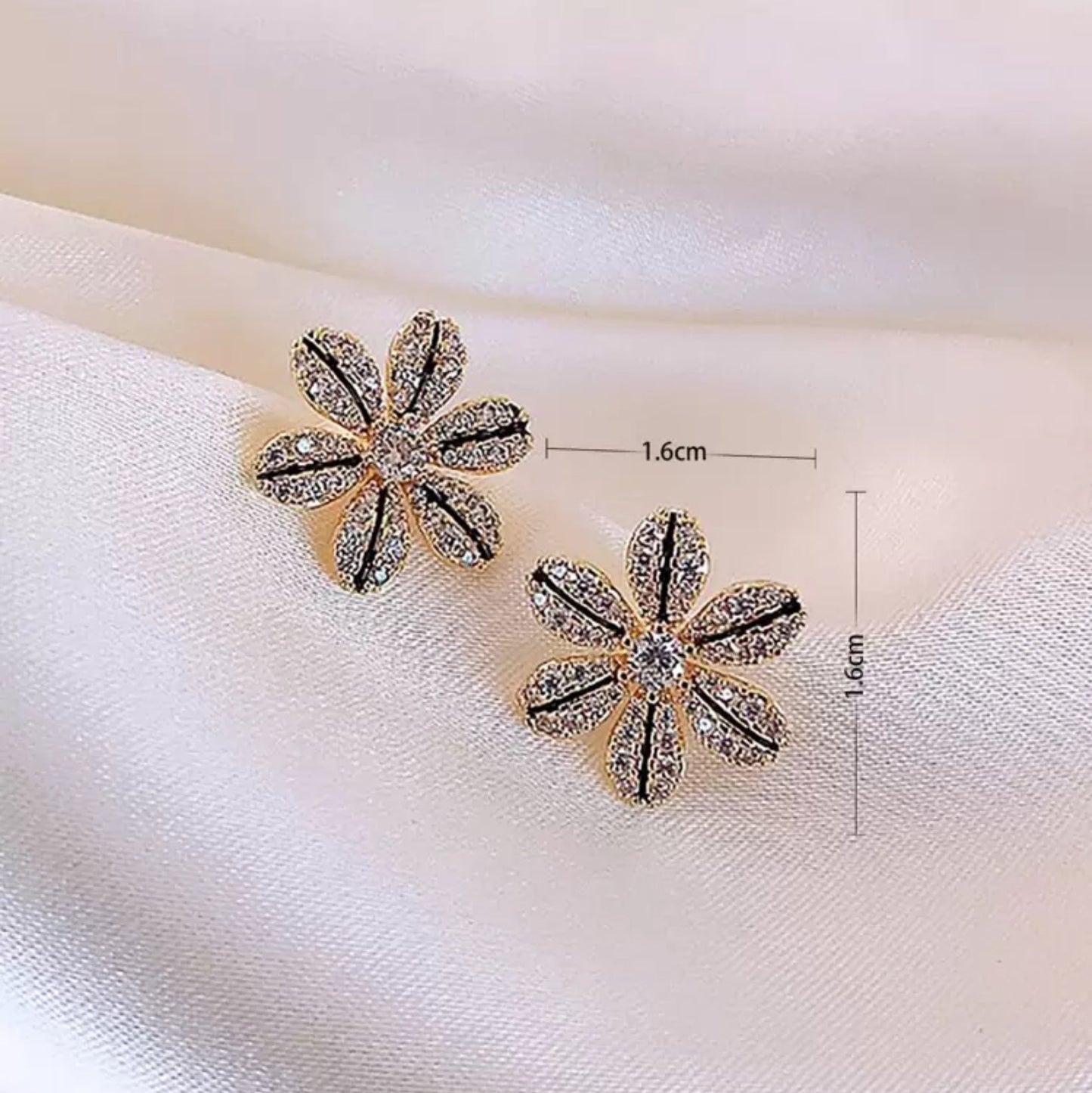 Black & Gold Rhinestone Flower Earrings with measurements on a white fabric background