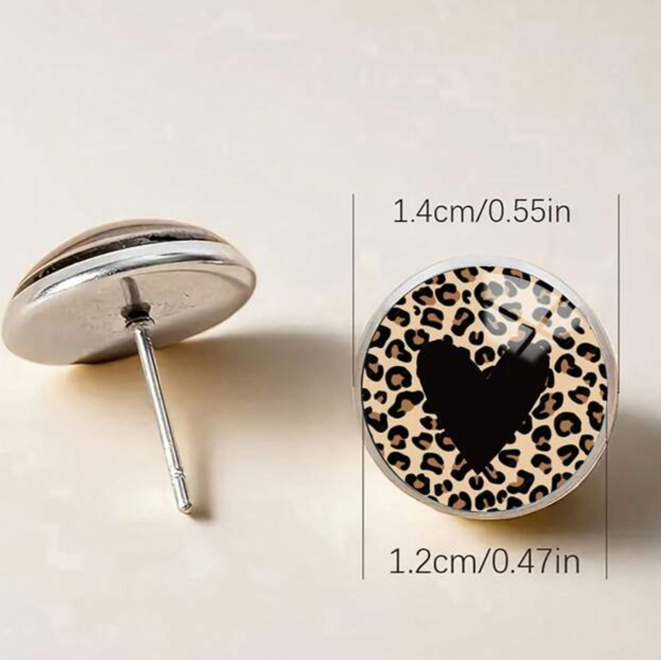Leopard print heart-shaped earrings with measurements on a light background