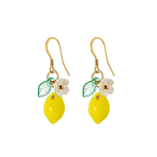 Pair of lemon-shaped earrings with gold hooks on a white background