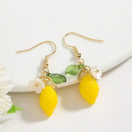 Gold stud earrings with lemon drops and white flower accents