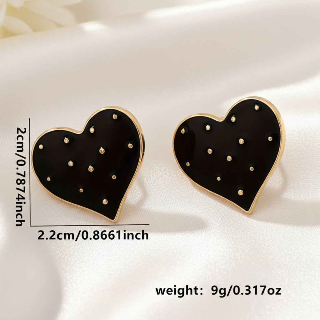 Moonlit Black Heart Earrings with black and gold details on a white fabric background, including measurements and weight information.