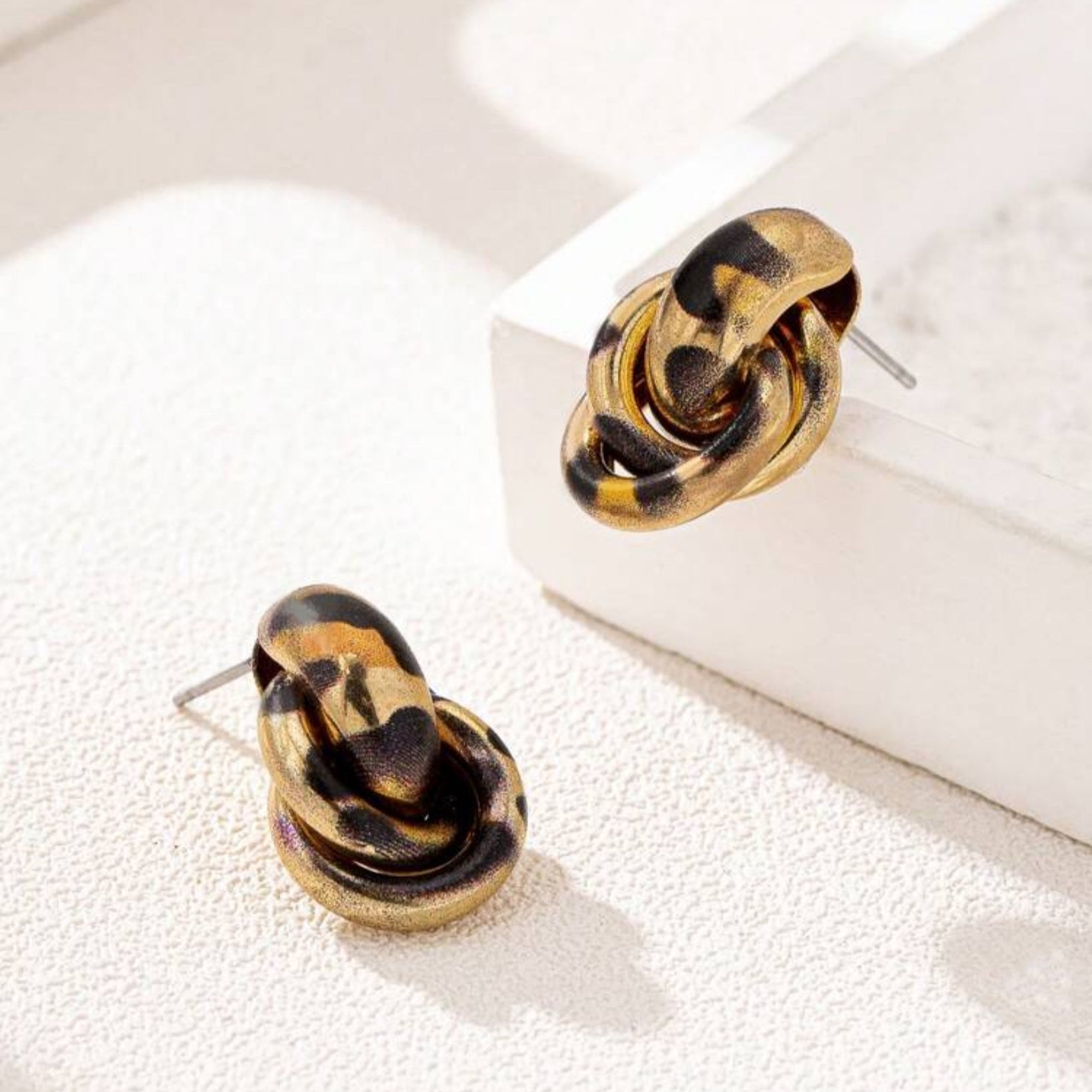 Leopard Circle Knot Earrings on a white surface
