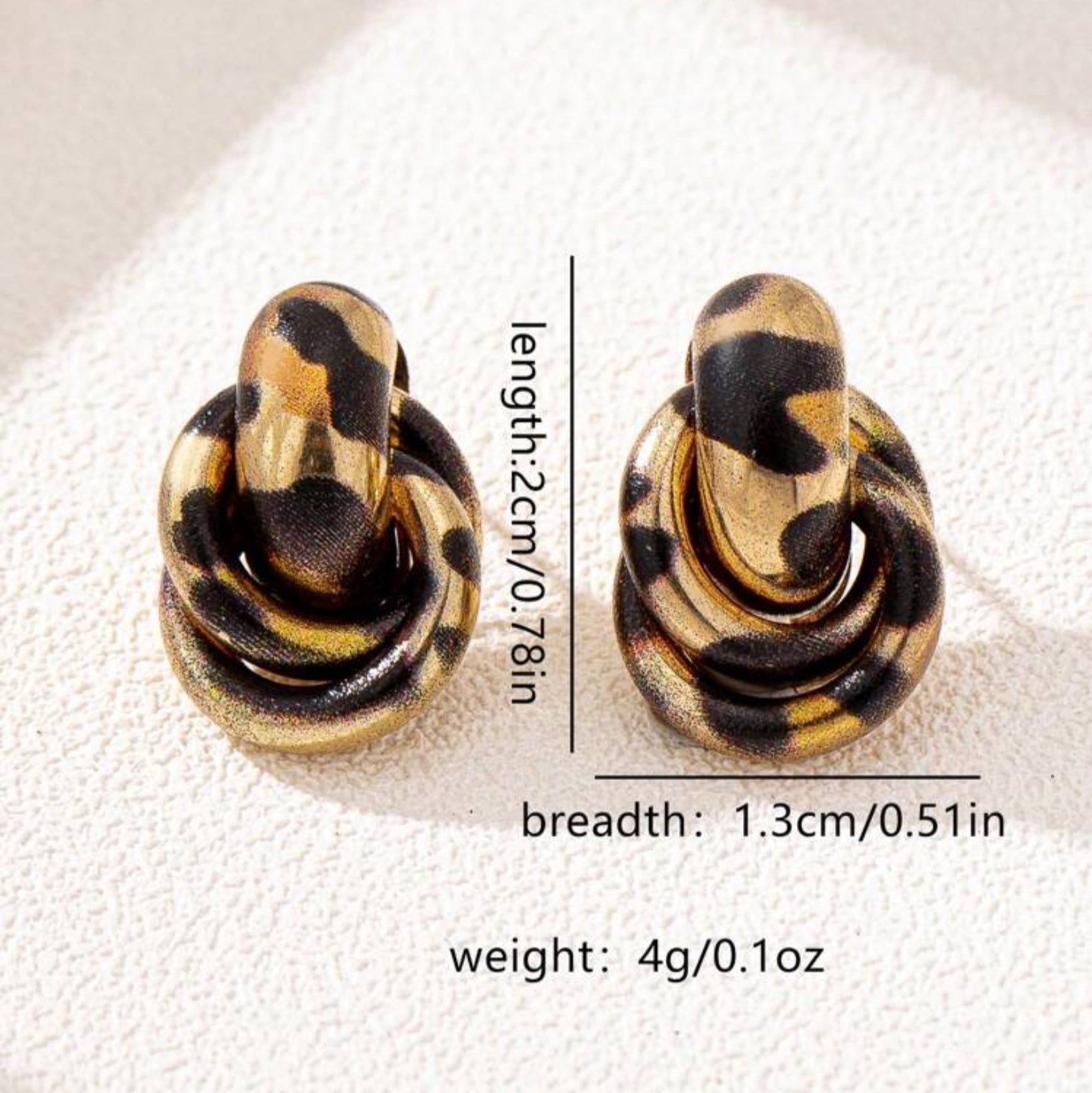Pair of Leopard Circle Knot Earrings with measurements on a white background