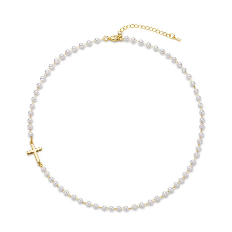 Gold Cross Pearl Necklace with a gold cross pendant on a white background