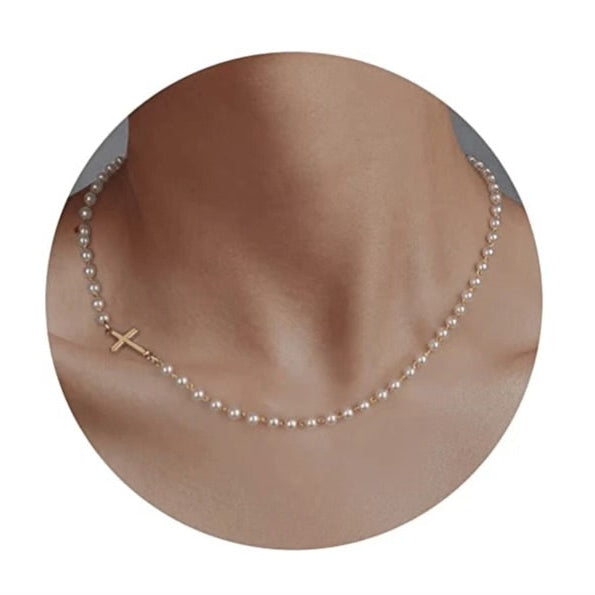 Gold Cross Pearl Necklace with a cross pendant on a mannequin neck