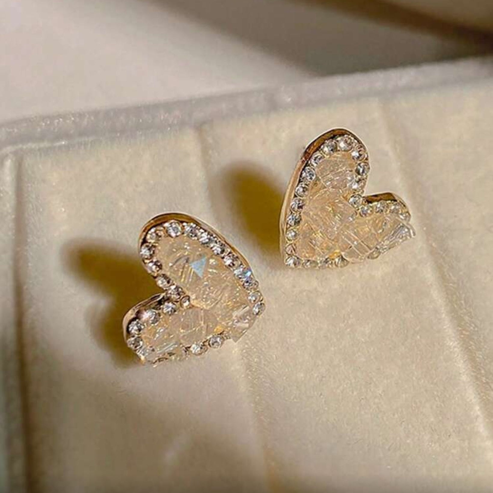 Champagne Heart Earrings on a soft fabric background