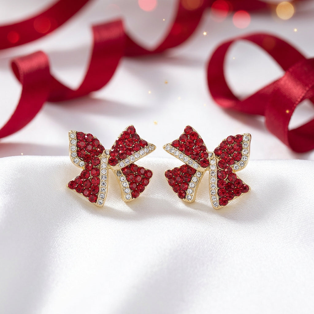 Red Rhinestone Bow Earrings with red gemstones on a white background