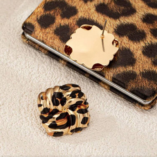 Leopard Square Knot Earrings on a textured surface with a leopard print phone case.