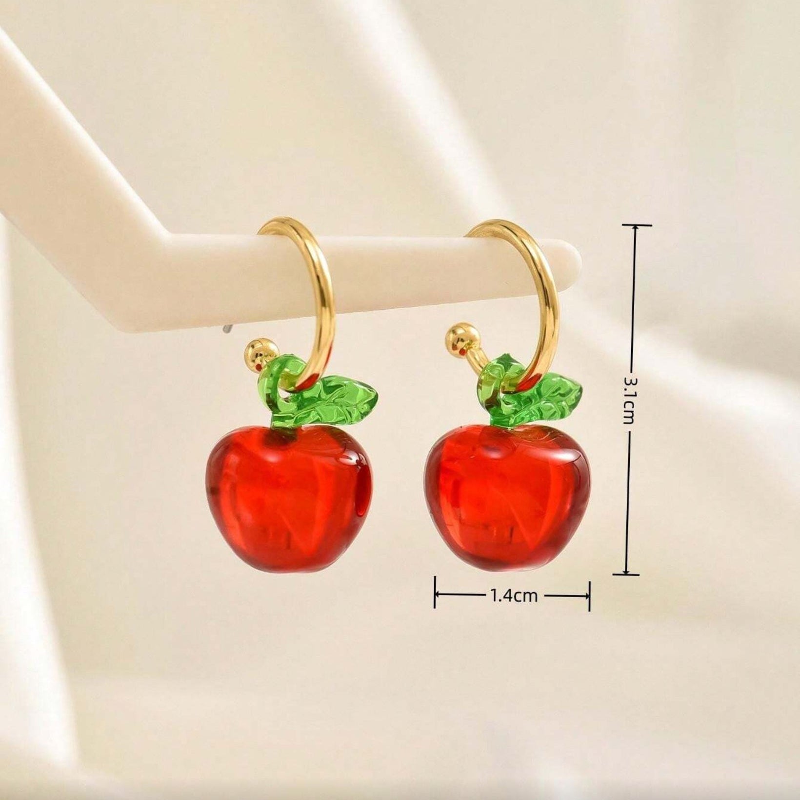 Red Apple Hoop Earrings with gold stems on a white background