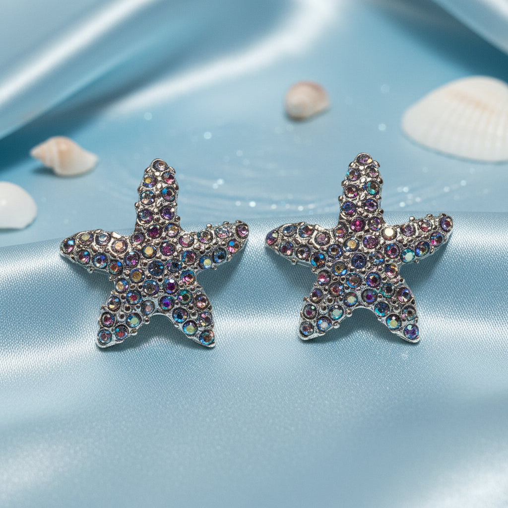 Iridescent Starfish Sparkle Earrings with colorful gemstones on a white stand.