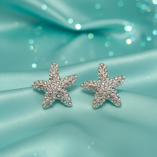 Iridescent Starfish Sparkle Earrings with rhinestones on aqua fabric