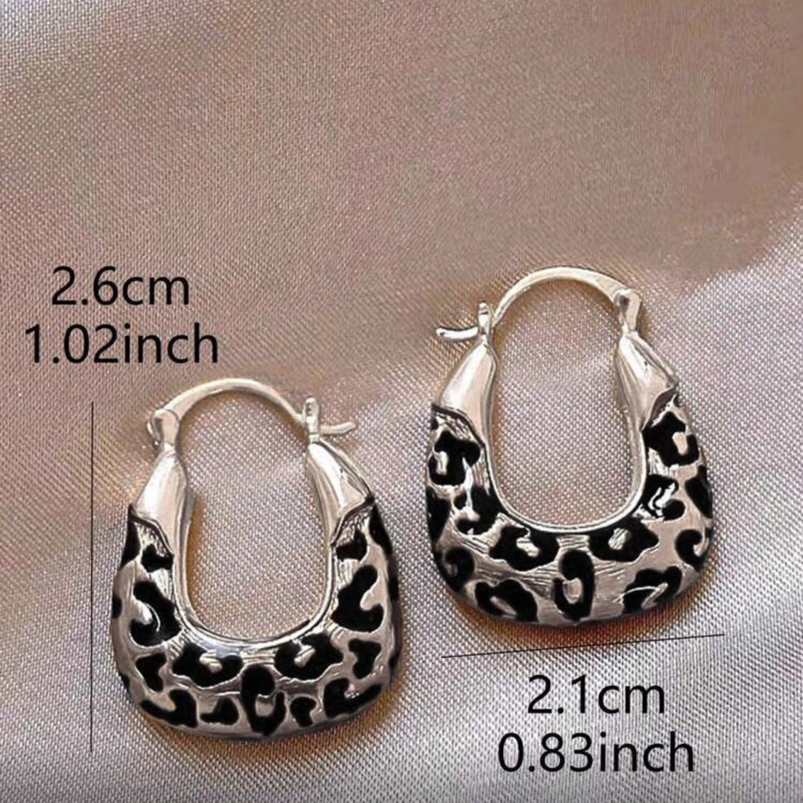 Silver Leopard Hoop Earrings on a gray background