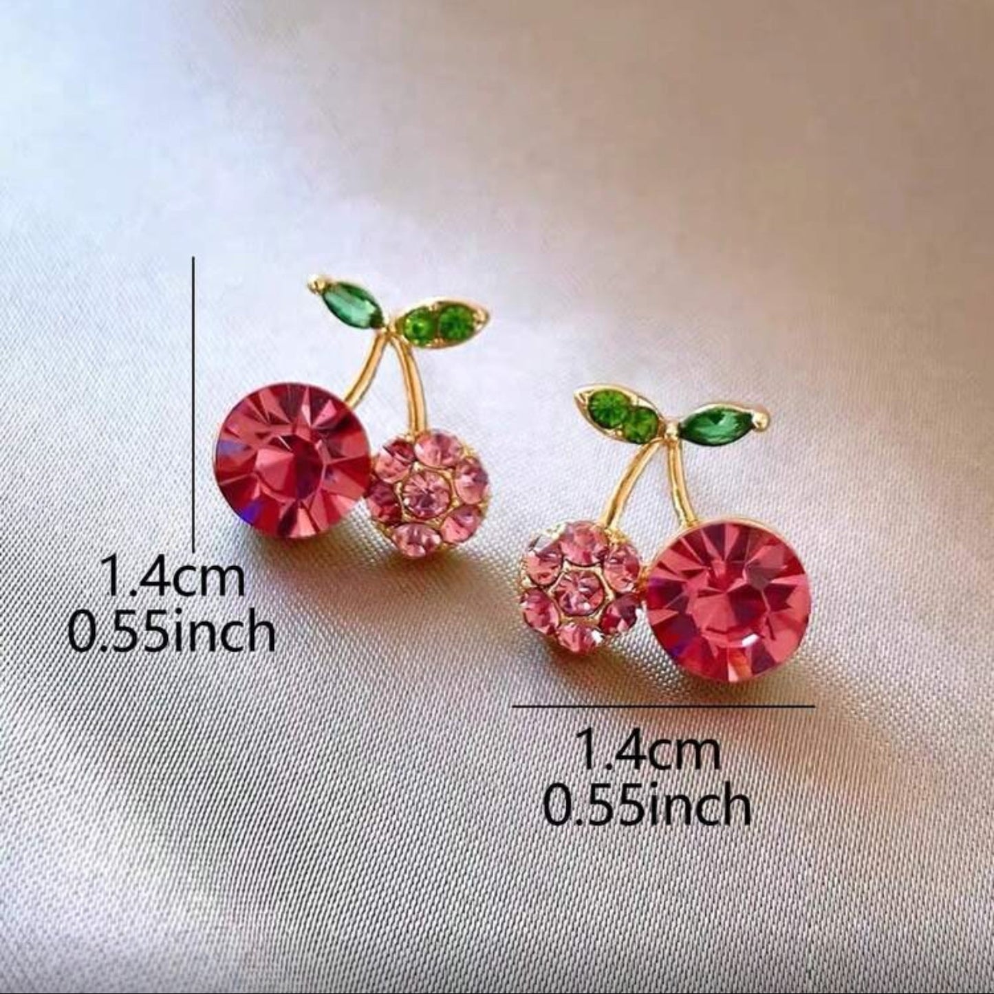 Pink Zircon Cherry earrings with gemstones on a light fabric background, showing measurements.