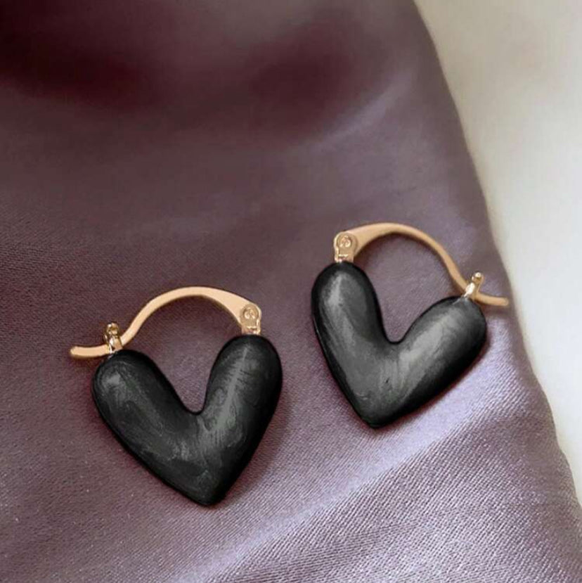 Gold hoop earrings accented with glossy black hearts
