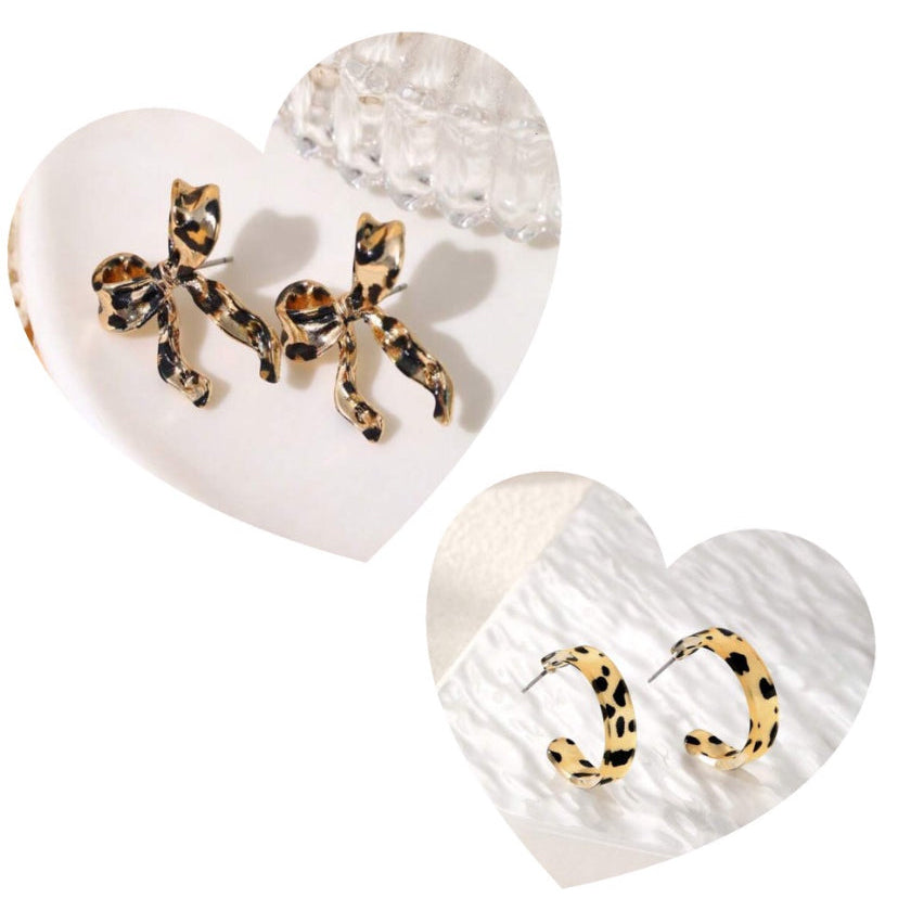 Heart-shaped earrings with leopard print details on a white background