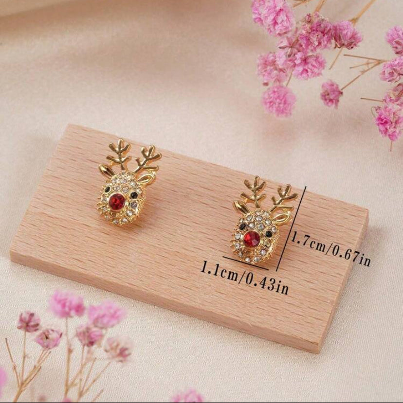 Rudolph Red Nose Reindeer Earrings on a wooden card with measurements, surrounded by pink flowers.