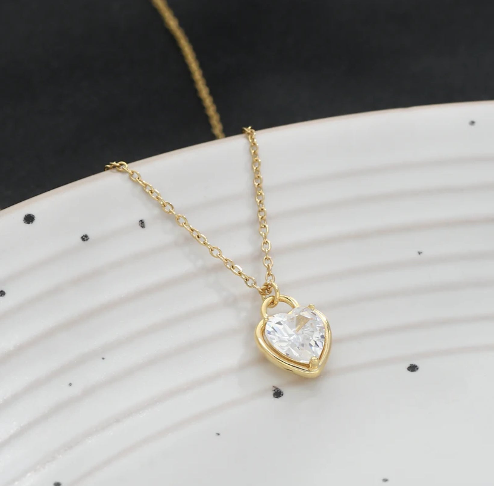 Super close-up of the Zircon Heart Locket Necklace showing the detailed zircon embellishments and locket design.