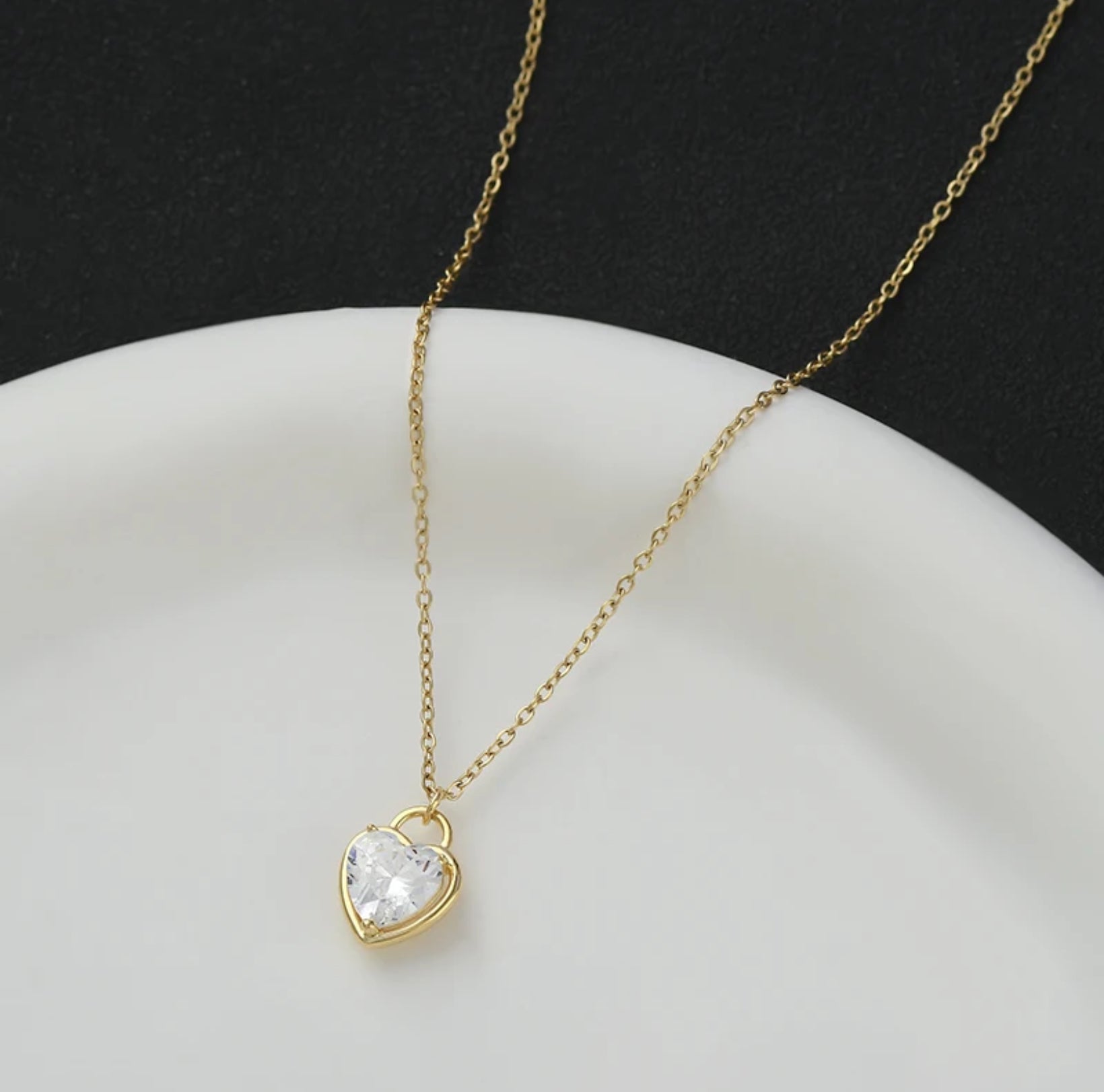 Close-up of the Zircon Heart Locket Necklace showing the detailed zircon embellishments and locket design.