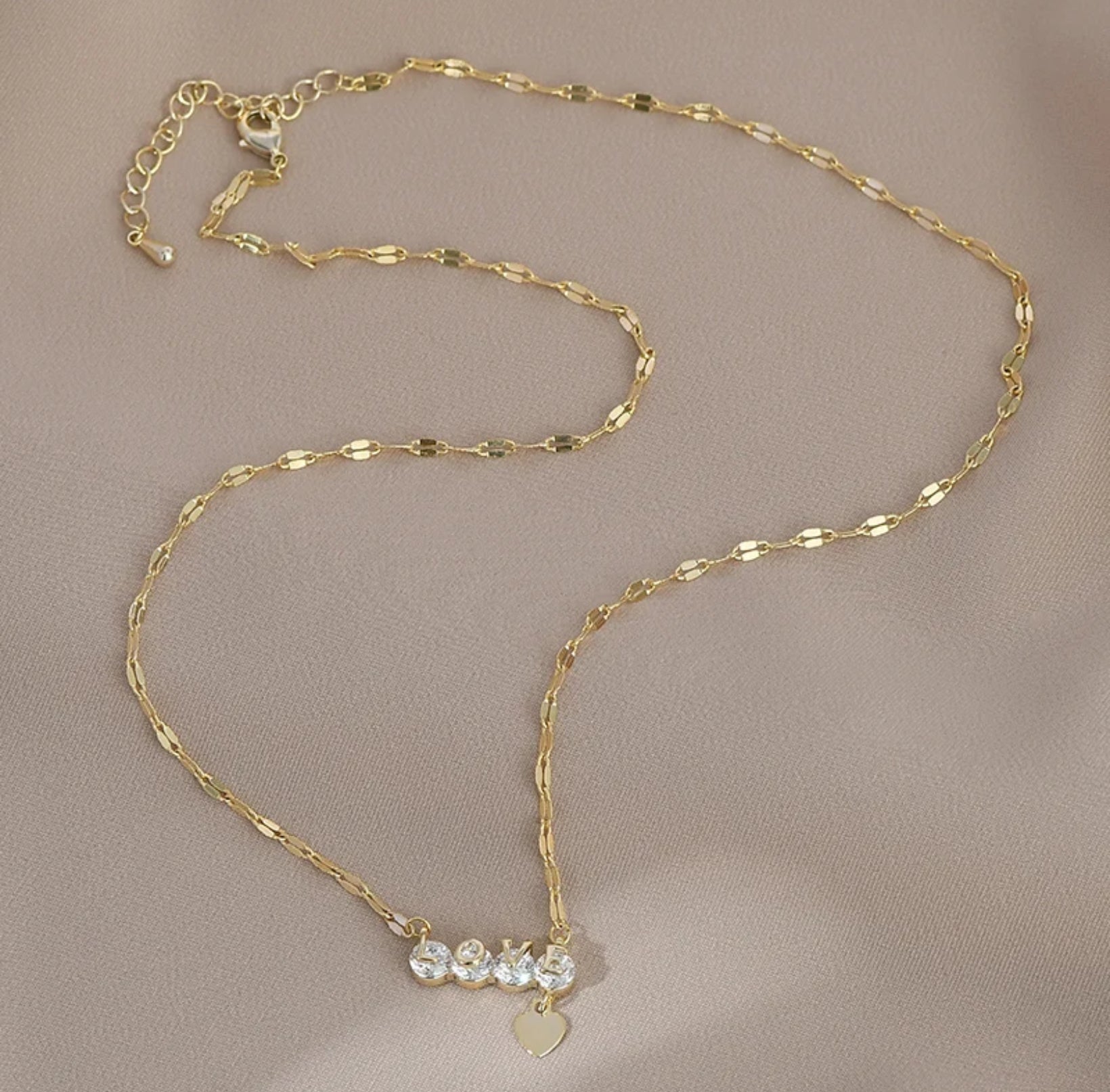 Zircon Love Heart Necklace featuring a sparkling heart-shaped zircon pendant on an adjustable 18-20" chain on beige background.