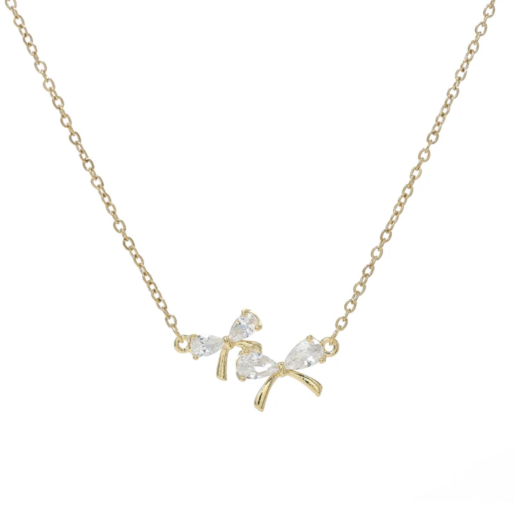 Zircon Bow Necklace, plain white background.