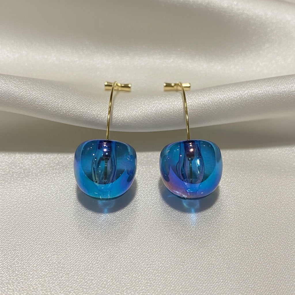 Iridescent Blue Cherry Drop Earrings on a light gray background