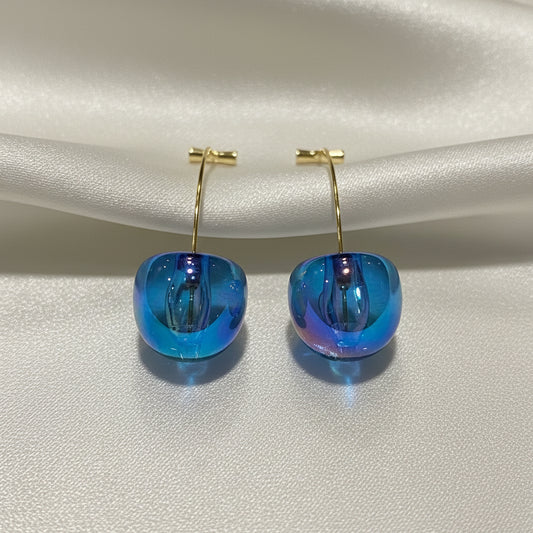 Iridescent Blue Cherry Drop Earrings on a light gray background